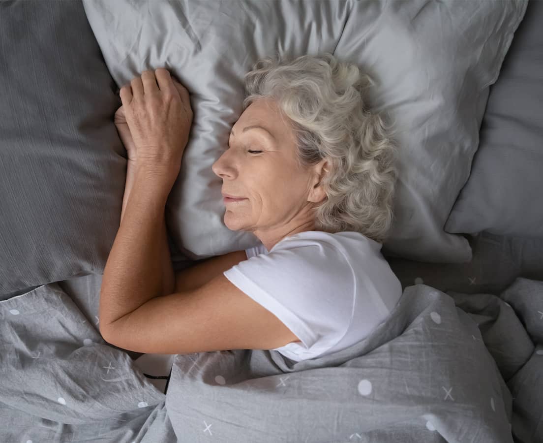 Shop for sleep support products, showing a woman sleeping