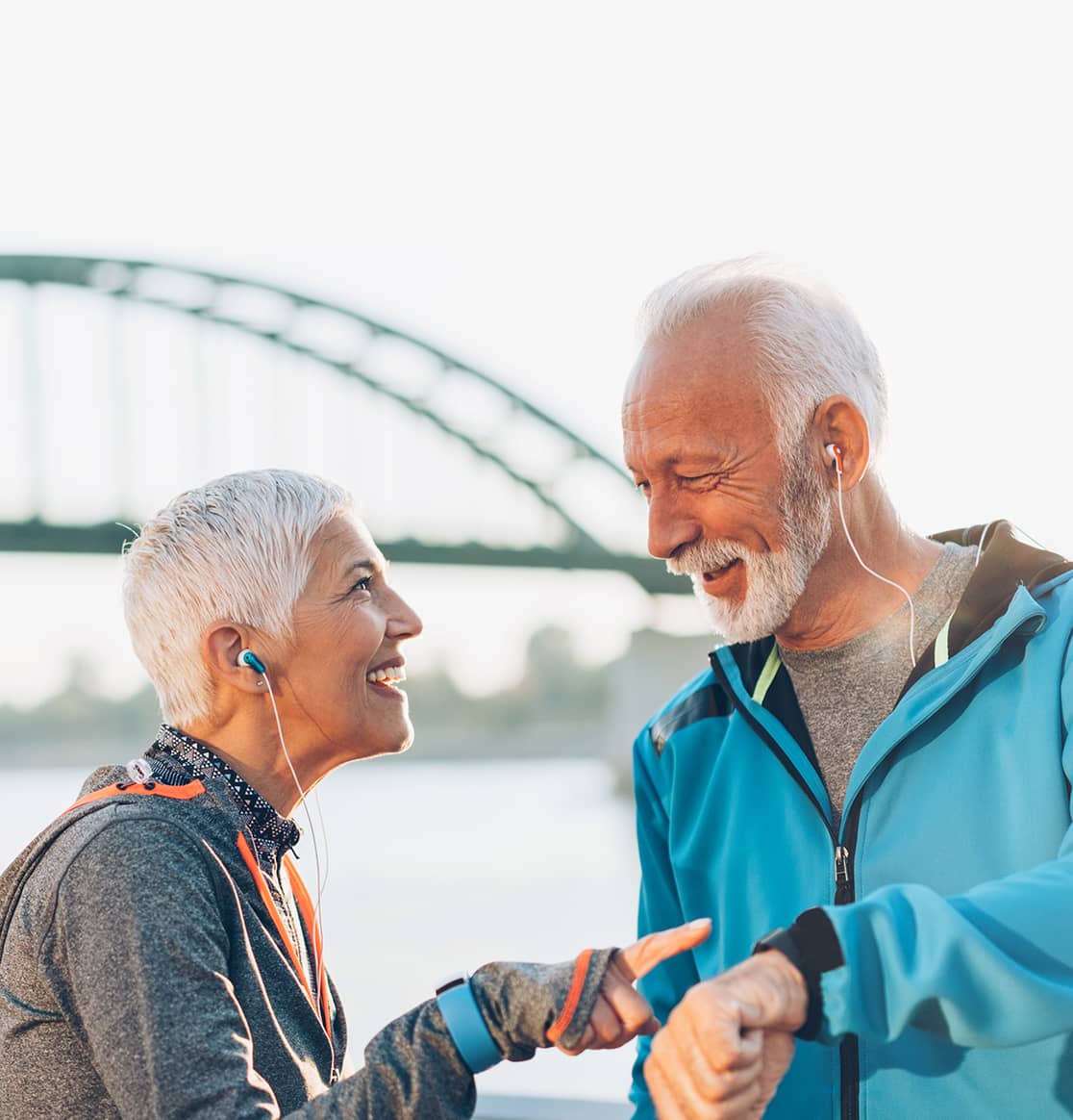 Shop for heart health products, showing a senior couple comparing exercise results outdoors