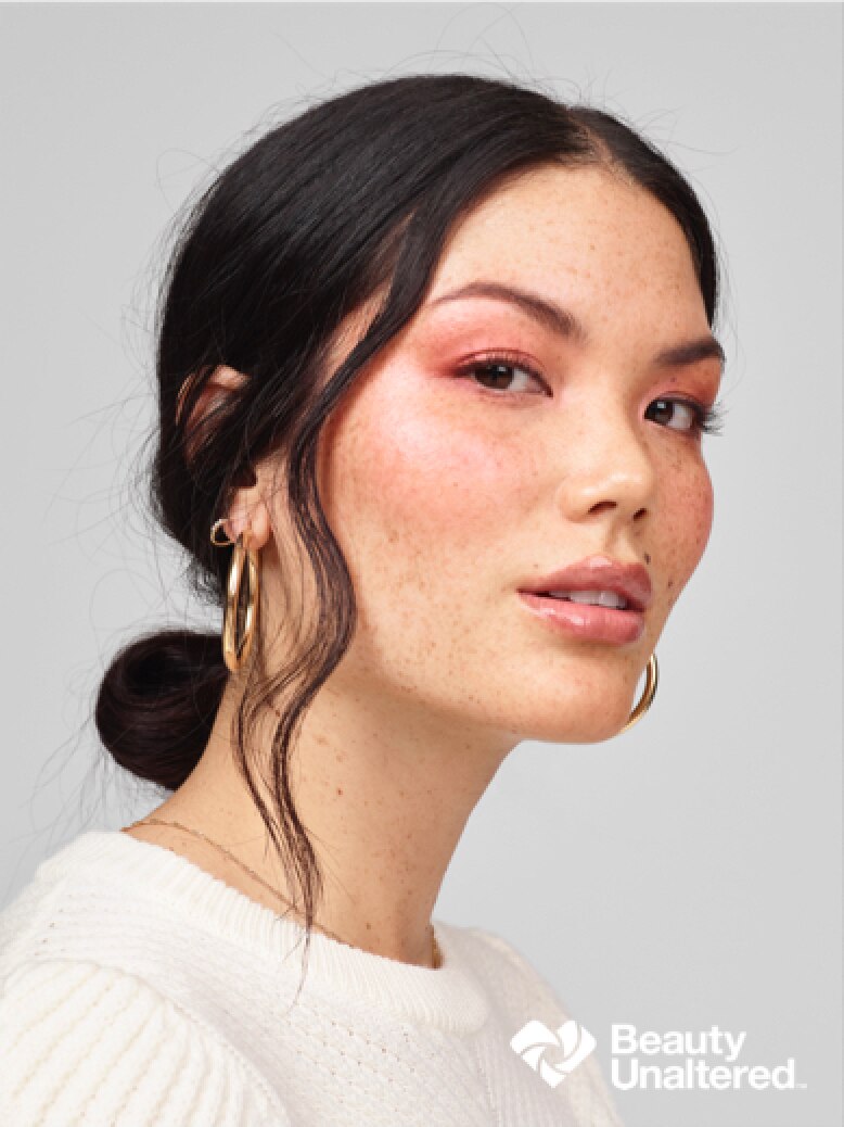 A split-screen image of the same female model. On the left side, the photo has not been digitally altered, and features the Beauty Unaltered logo.