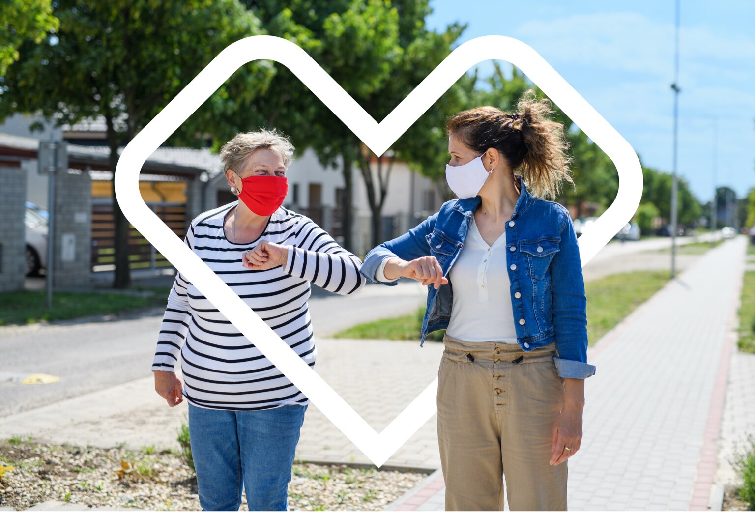 An image of two women in face coverings bumping elbows