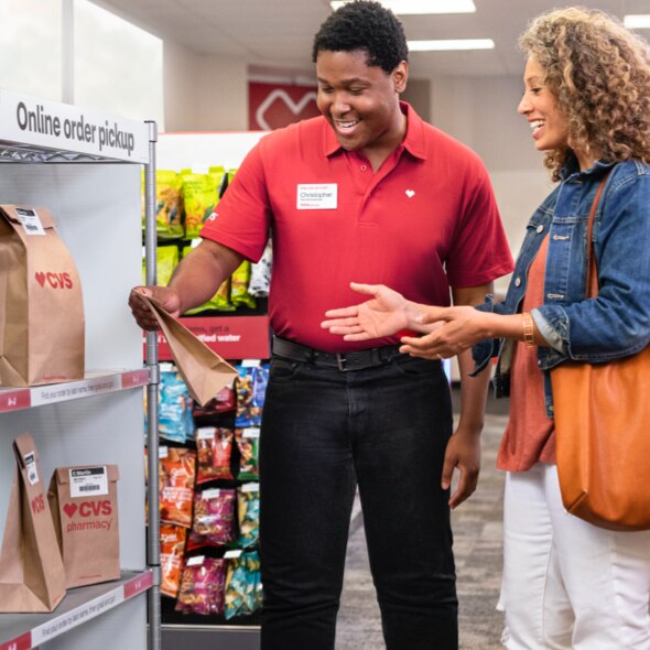 A CVS colleague assists a shopper with her pickup order.