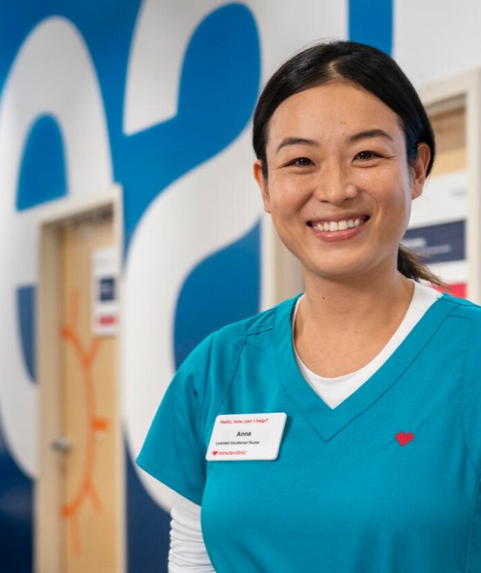 A smiling health care professional inside a CVS HealthHUB