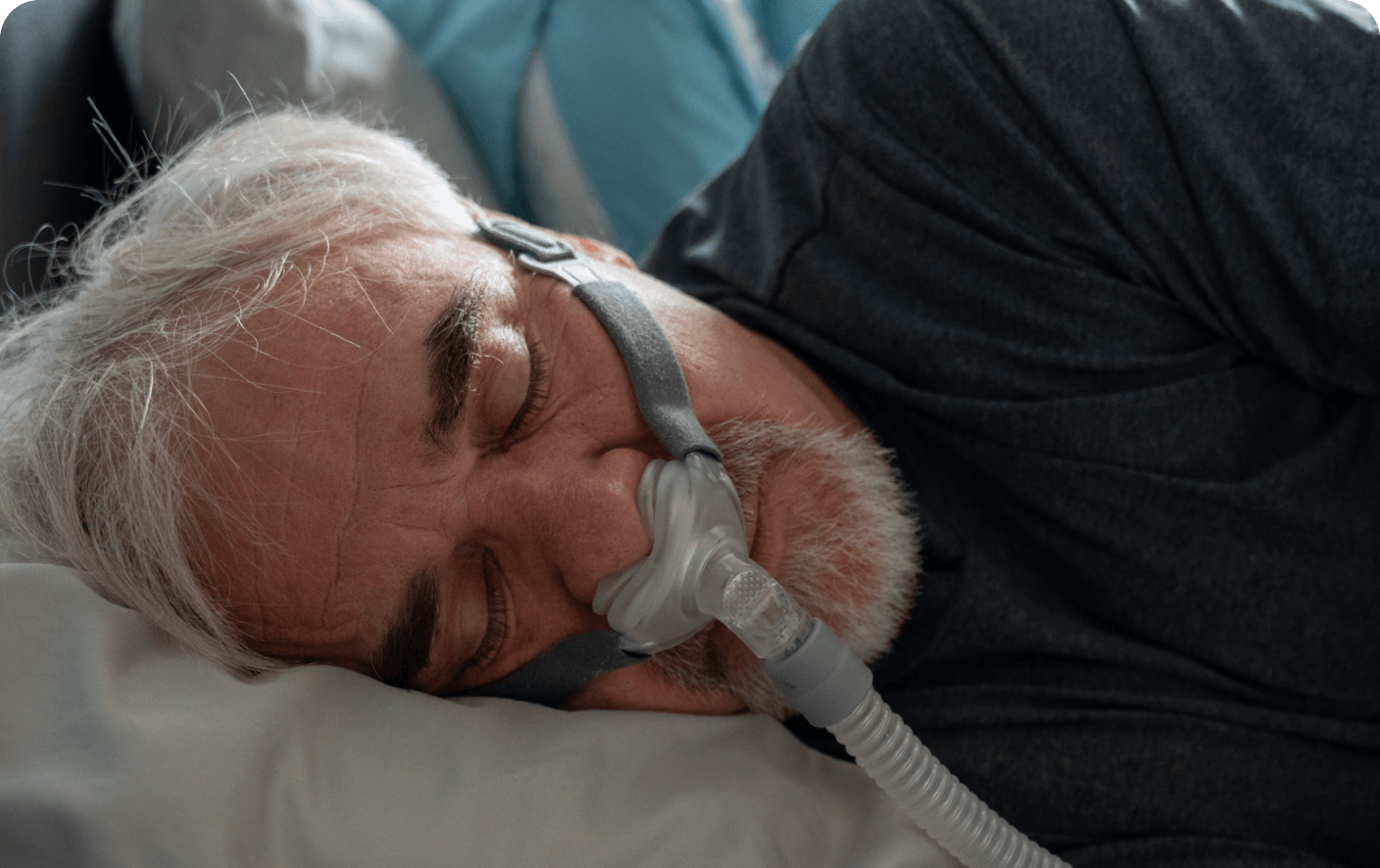 Hombre en una cama utilizando un dispositivo CPAP