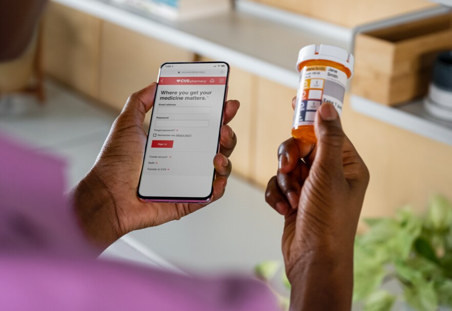 Patient comparing prescription bottle with information found on the CVS app. Learn more about prescription services now.