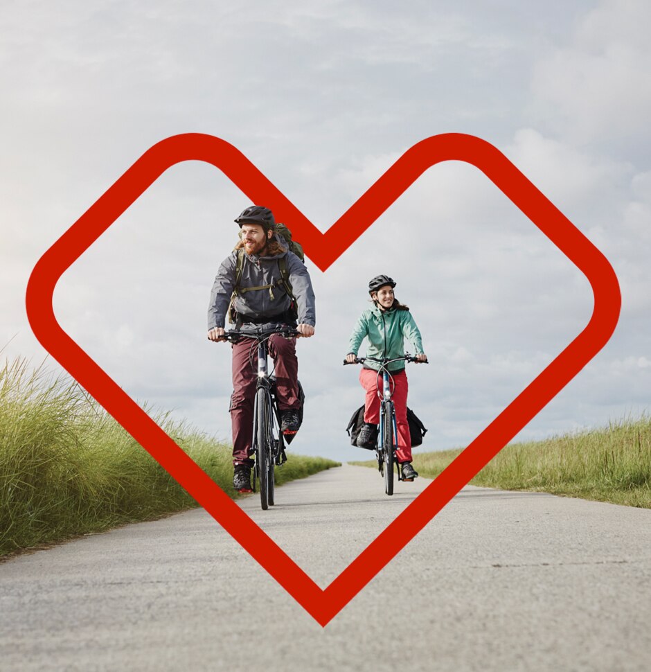 Young couple riding bikes on open bike path road with overlaid CVS logo