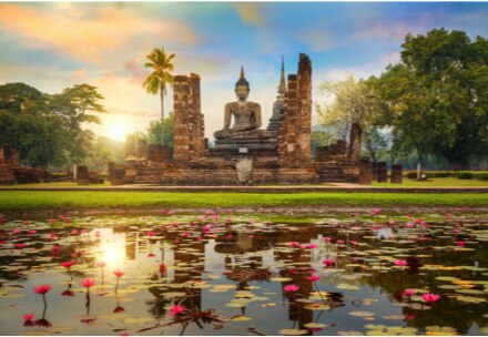 Buddha statue overlooking a pond in Thailand