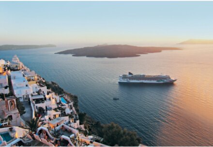 aerial view of a cruise ship offshore of an island town