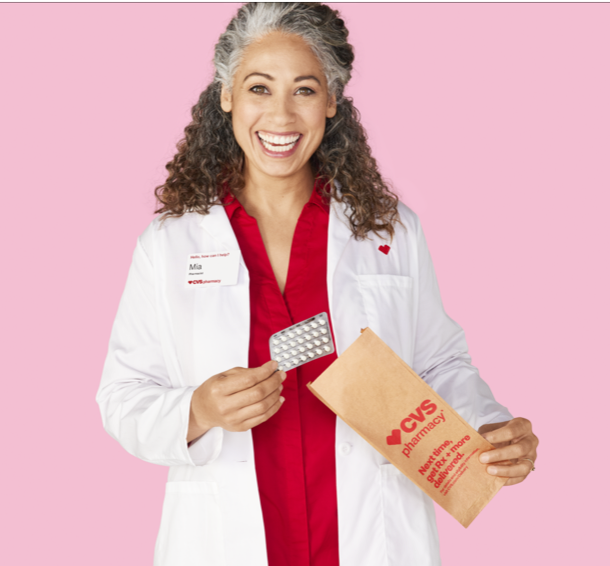 CVS® pharmacist pulling a birth control pill packet from a prescription bag.