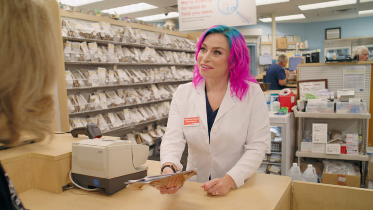 Pharmacist Meghan consults a patient at the pharmacy counter.