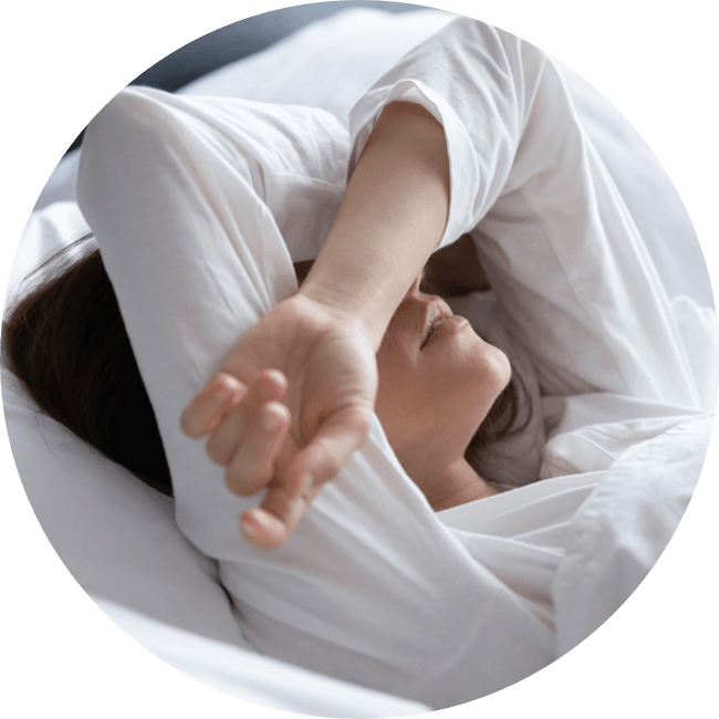 Woman lying in bed struggling to sleep