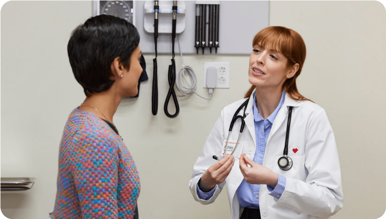 a woman health care provider and her female patient discuss period health.