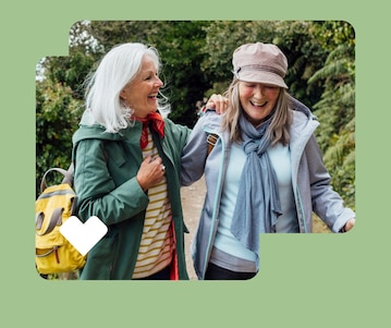 Two friends talk while taking a walk together.