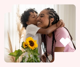 A mother and child embrace in their living room.