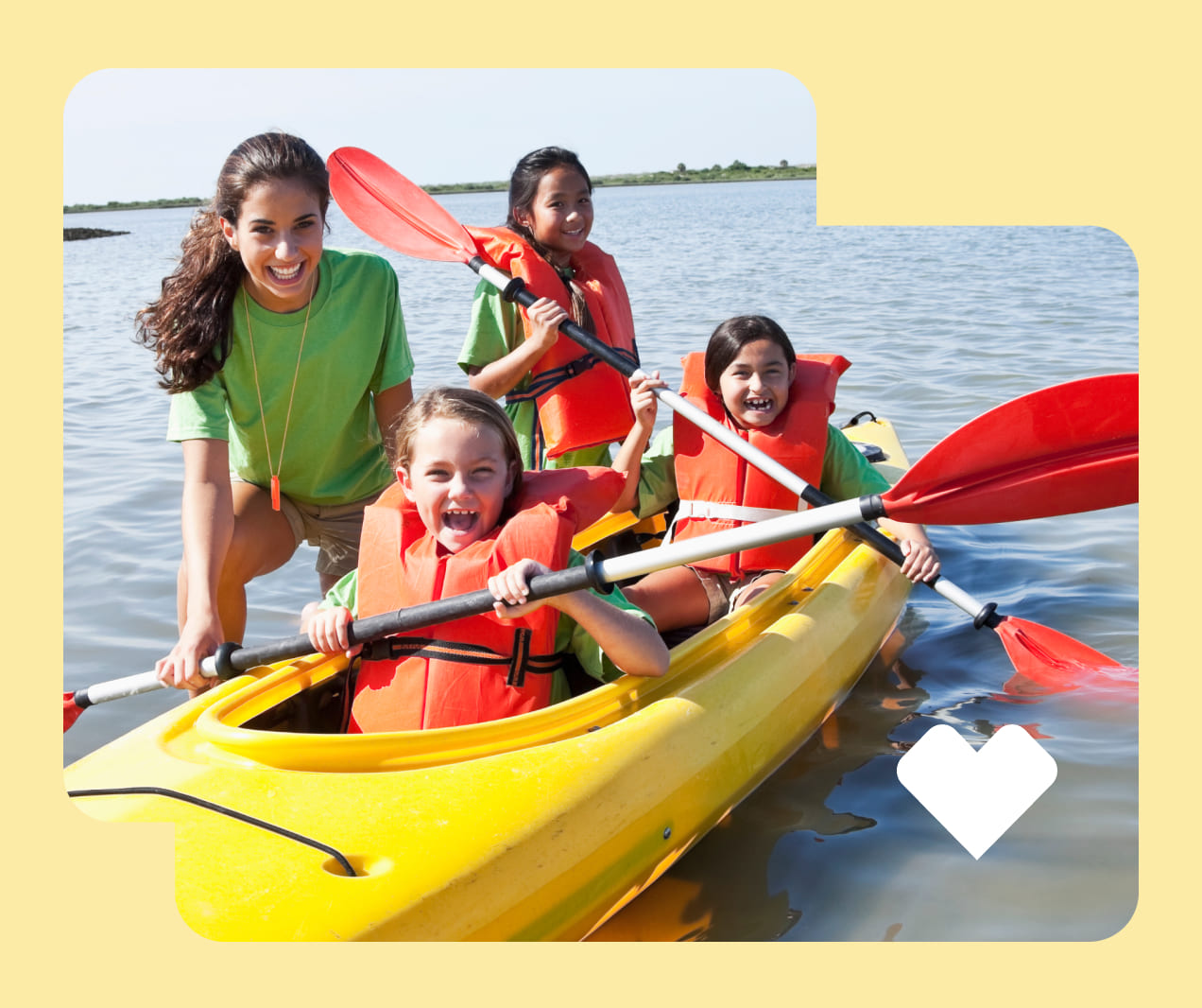 A camp counselor teaches kids to kayak.