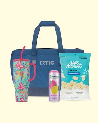 A cooler, tumbler, energy drink and well market popcorn.