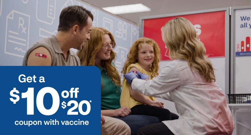 A certified immunizer places a bandage on a child's arm after vaccination.