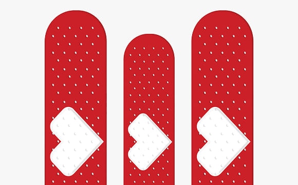 Three adhesive bandages with the CVS Health heart printed on them