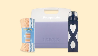 A beach towel, cooler and water bottle.