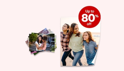 A stack of prints of family photos and repositionable poster showing three siblings arm-in-arm on the beach.