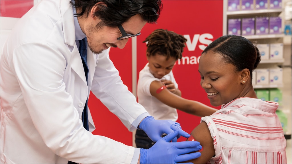 A mother and child receive their vaccinations from CVS.