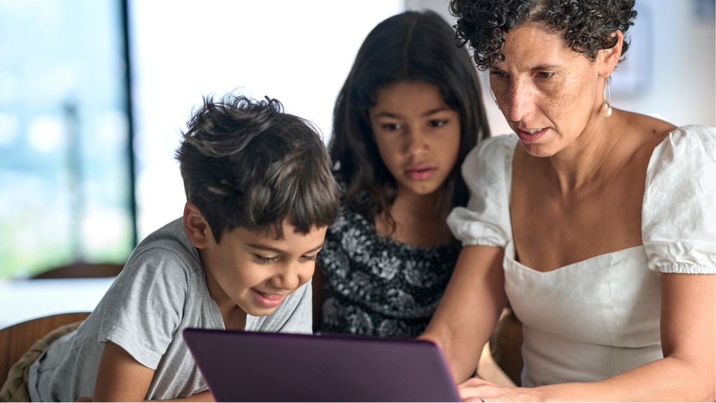 A mother and her two children review vaccine information online together.