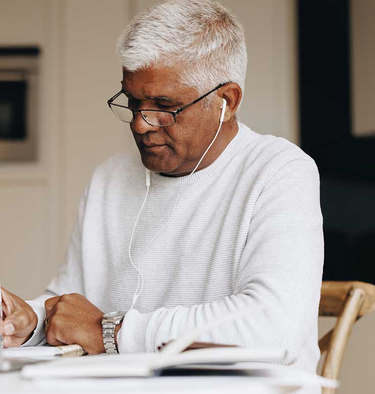 A person sits at their desk focusing on one task at a time to help reduce distractions.