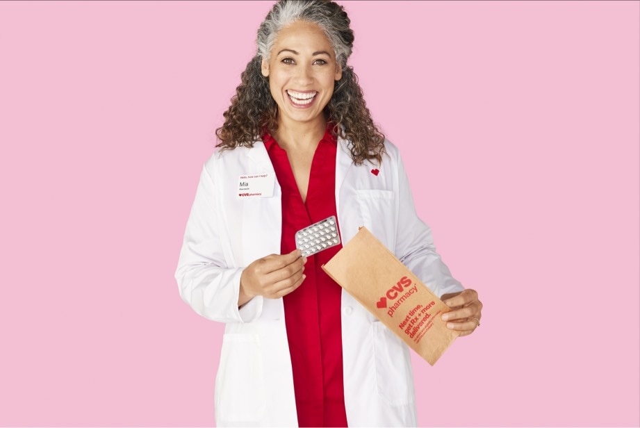 CVS® pharmacist pulling a birth control pill packet from a prescription bag.