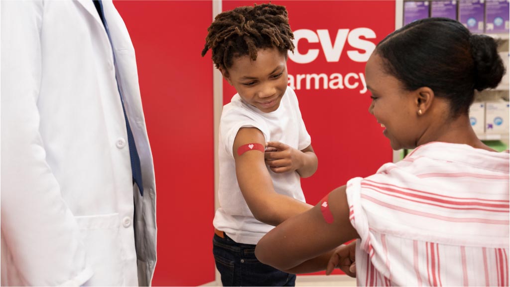A mother and child receive their vaccinations from CVS.