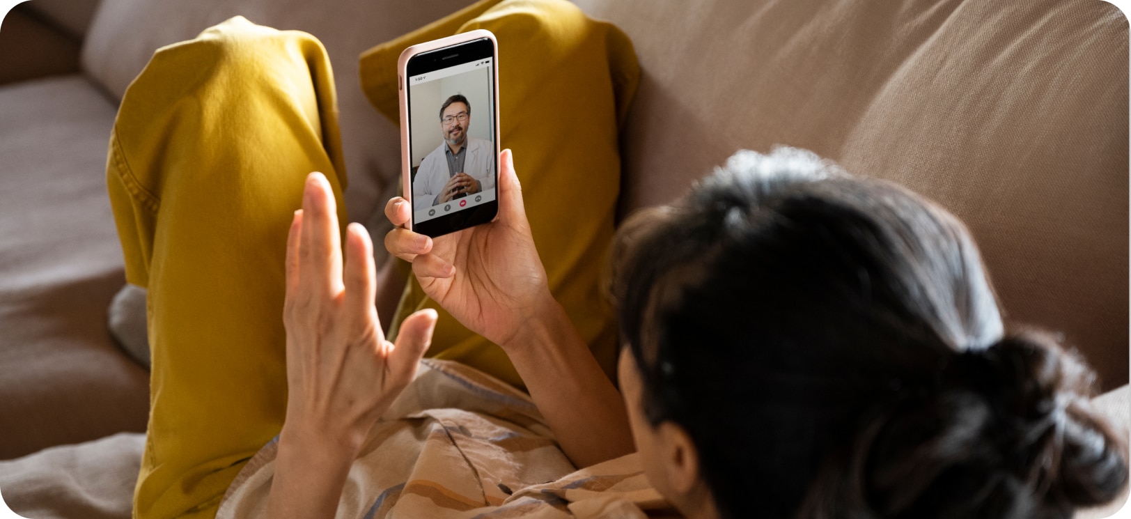 A woman speaks to her doctor on a telehealth call.