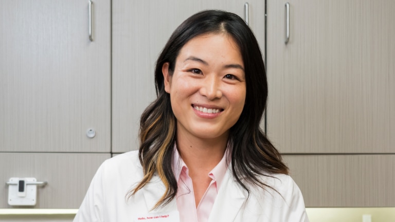 A smiling clinician waits for her next patient at a CVS on-site clinic.