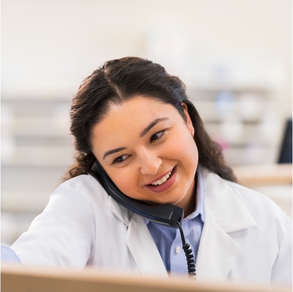 A CVS Pharmacist provides a consultation over the phone to a patient.