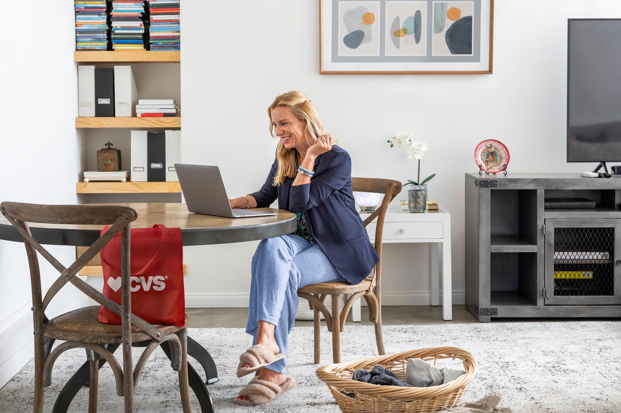 Happy woman at home looking at her computer screen