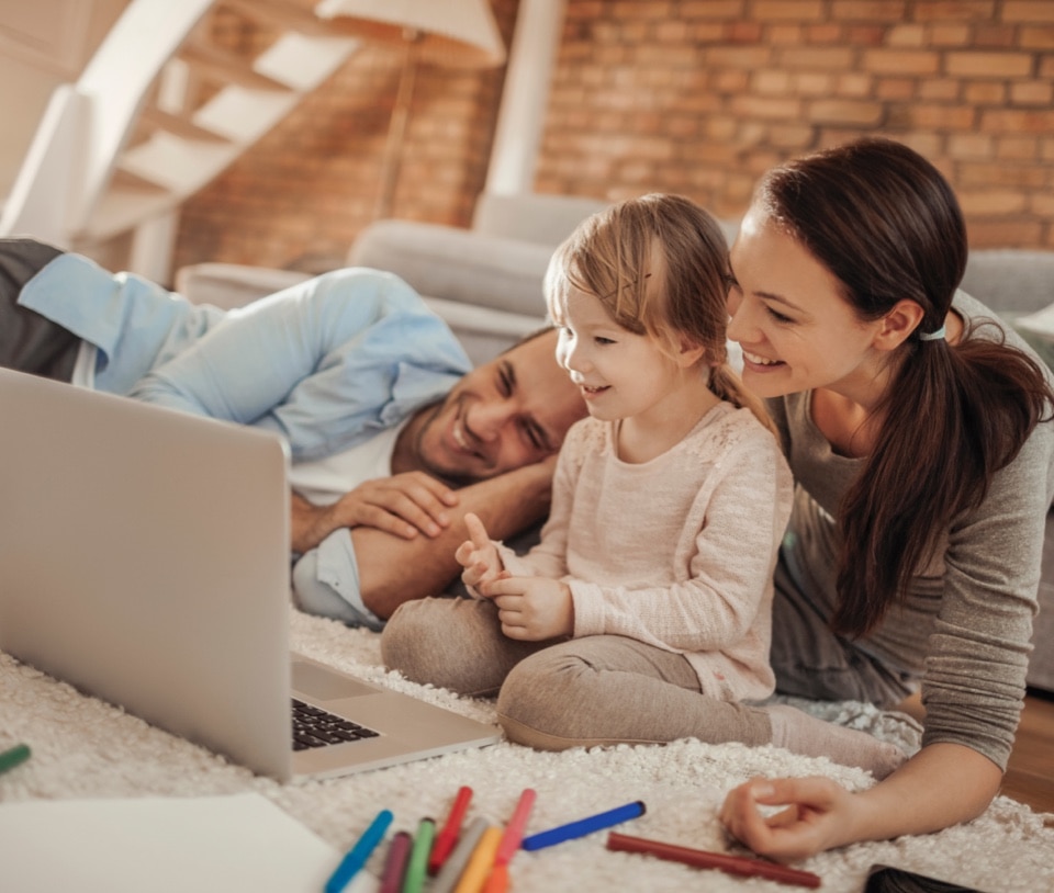 Man, woman and little child playing on the floor