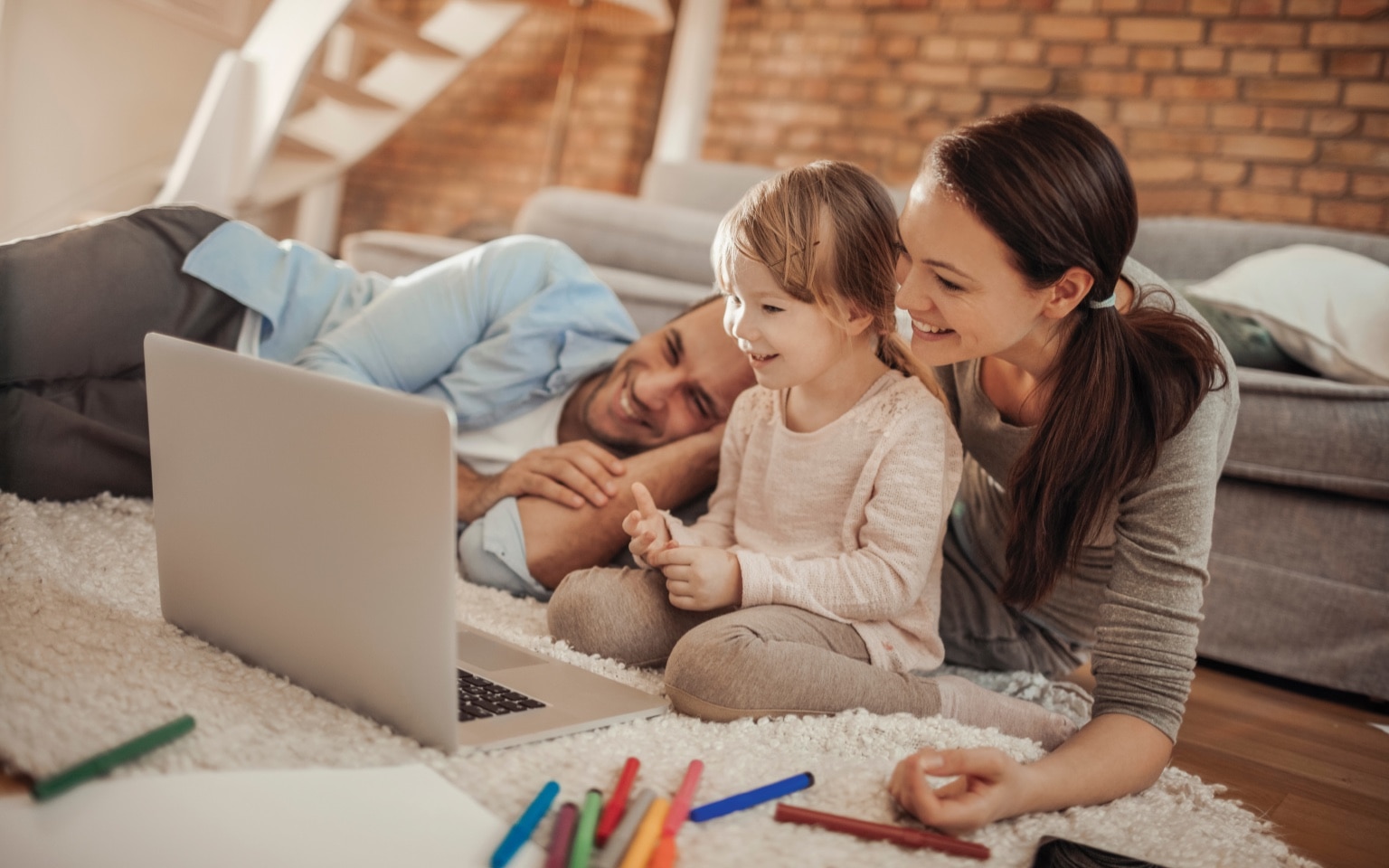 Man, woman and little child playing on the floor